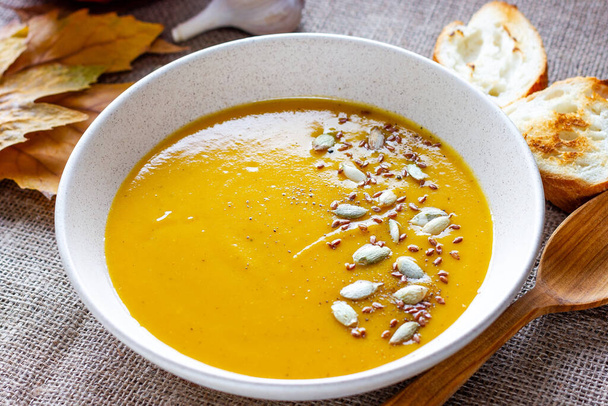 Healthy, vegan food. Pumpkin soup with pumpkin seeds - 写真・画像