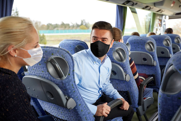 passengers in masks talking in travel bus - Zdjęcie, obraz