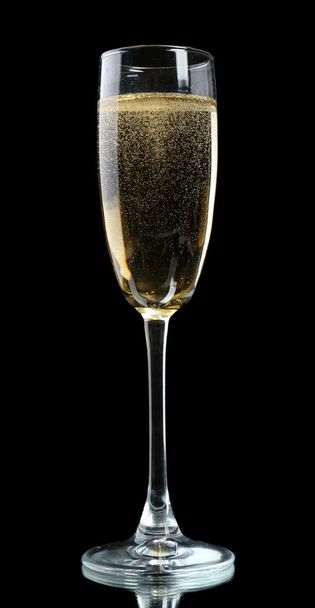 Glass of champagne, on black background - 写真・画像