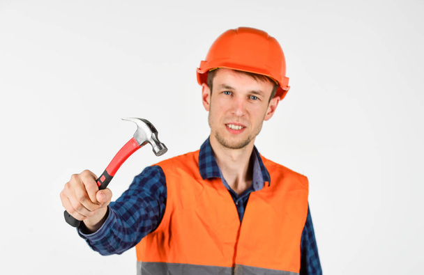 repairman in uniform. man work with hammer. real construction worker in helmet. carpenter ready to work. building tool repair equipment. young worker is engineer assistant. fixing everything - Фото, зображення