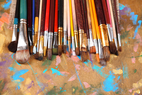 Brushes on multicolor  wooden background  - Φωτογραφία, εικόνα