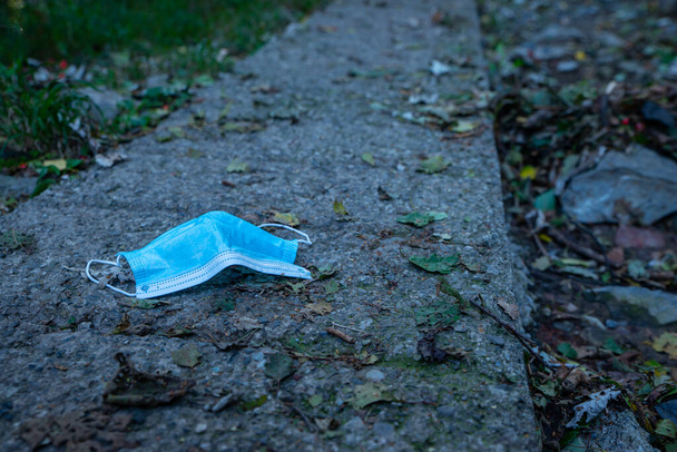 Surgical mask thrown into the environment - Photo, Image