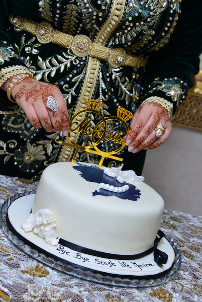 Marocká henna. Ruka marocké nevěsty vytetované s hennou držící svatební dort - Fotografie, Obrázek
