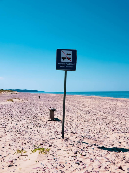 a sign indicating the boundaries of the beach for nudists in Latvia - Photo, Image