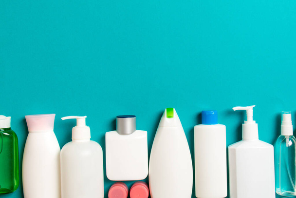 Top view of cosmetics bottles on colored background. Skin care concept with space for your design. - Фото, зображення