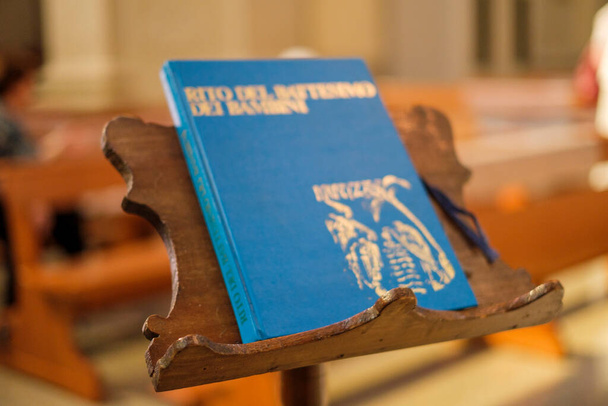 religious book rite of baptism on lectern in church in Italian. High quality photo - Photo, Image