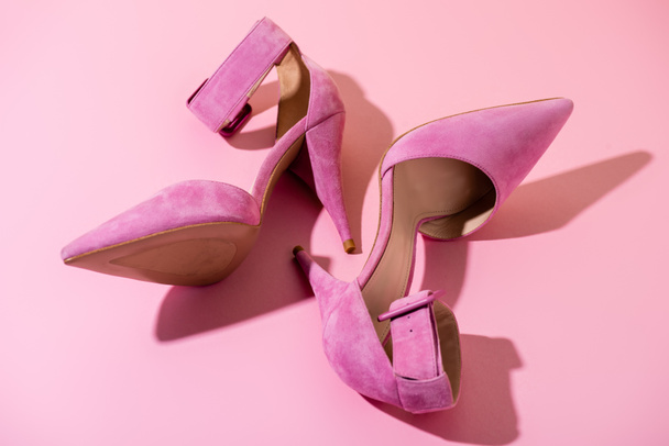 pair of elegant suede heeled shoes on pink background - Photo, Image