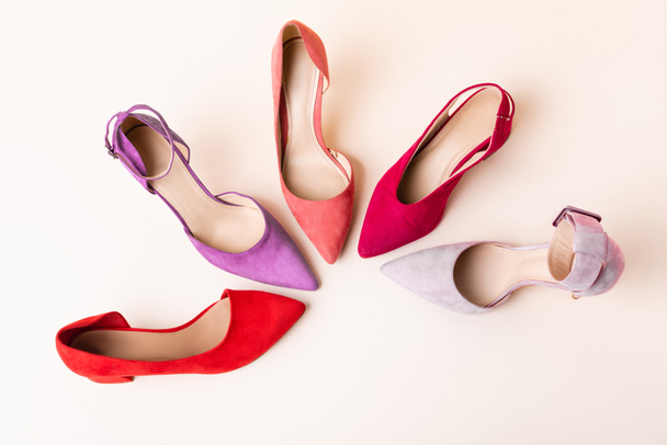 top view of suede colorful heeled shoes on beige background - Photo, Image