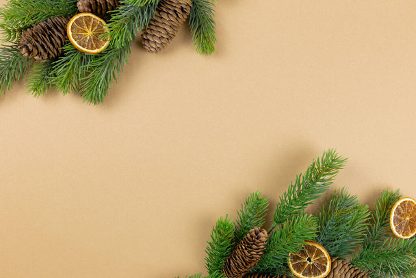 Christmas background. Fir tree branch and christmas decorations on paper background. Top view. Copy space. Christmas, winter, new year concept, flat lay. - Photo, image