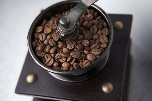 A closeup shot of coffee beans in a grinder - Foto, Bild