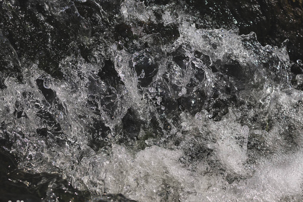 A black and white shot of a waterfall and splashing stream - perfect for background - Valokuva, kuva