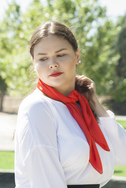 A vertical shot of a Caucasian woman with red lipstick and a scarf - Fotoğraf, Görsel