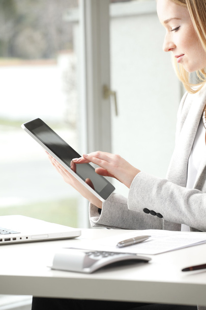 Businesswoman is typing on her tablet - Photo, Image