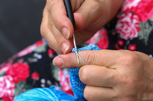 A closeup shot of a needlewoman knitting a toy - handmade craft concept - Foto, Imagen