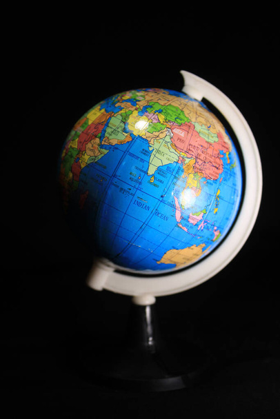 Earth globe isolated on a black background. School globe on black background. - Fotó, kép