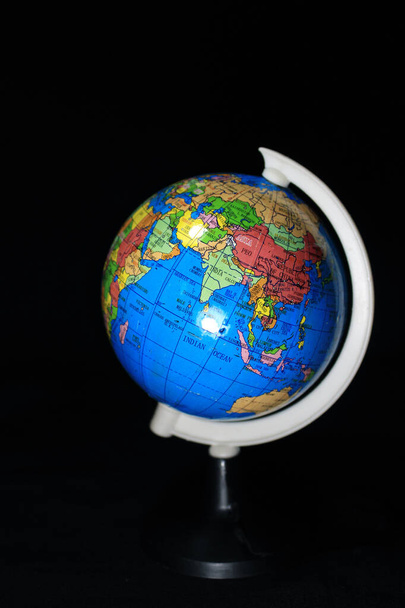 Earth globe isolated on a black background. School globe on black background. - Photo, Image