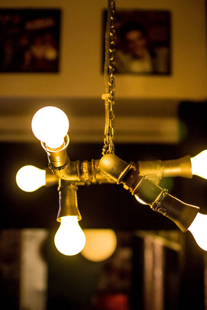 A vertical shot of a lit vintage chandelier - Foto, afbeelding