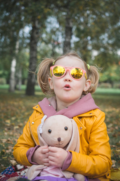 three year old cheerful girl child playing on picnic in autumn park - Φωτογραφία, εικόνα