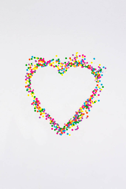 Heart shape made with multi coloured confetti sprinkles - Foto, afbeelding