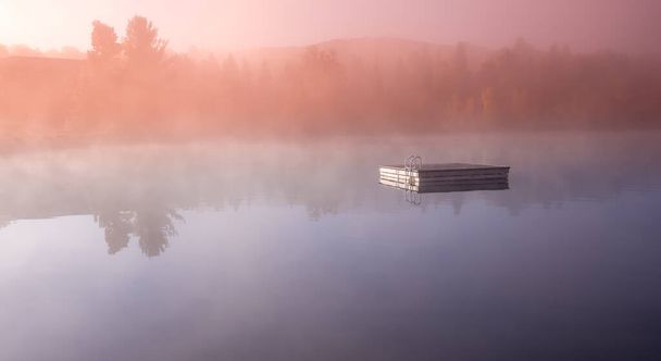 view of a boat dock the Lac-Superieur, misty morning with fog, in Laurentides, Mont-tremblant, Quebec, Canada - Photo, Image