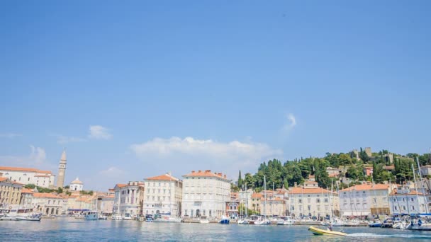 A small yellow speedboat is approaching the harbour. It's a nice summer day in a sea town of Piran. - Footage, Video