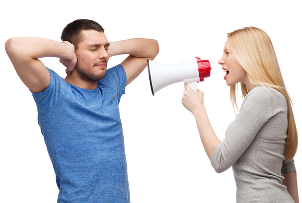 Girlfriend screaming though megaphone at boyfriend - Foto, Imagen