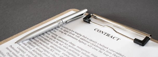 Pen and contract papers on wooden desk - Фото, изображение