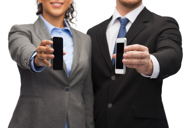 Businessman and businesswoman with smartphones - Foto, Bild