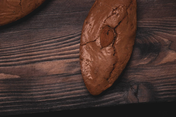 Delicious almond cookies on a wooden background - Valokuva, kuva