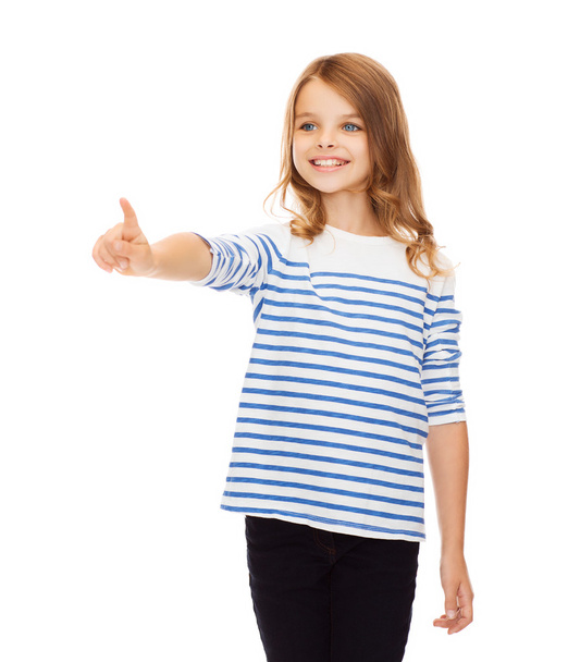 Cute girl pointing in the air or virtual screen - Foto, imagen