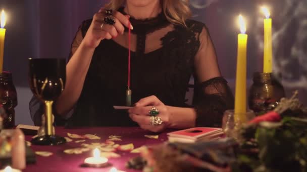 Detailní záběr ženy věštkyně drží magické kyvadlo nad fotkou ztracené osoby - Záběry, video