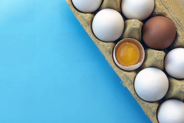 Egg, chicken egg in a tray on a blue background. Close-up. - Photo, Image