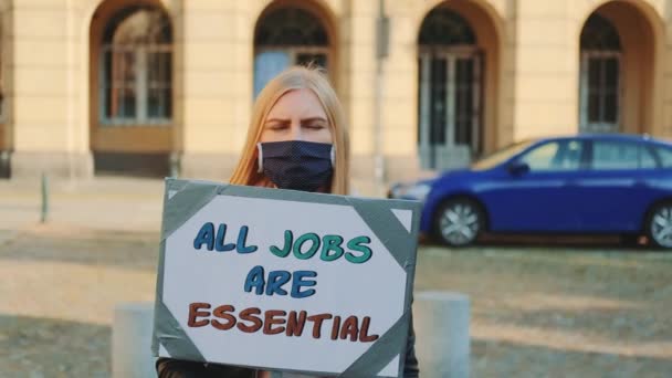 On protest march woman drawing attention to the importance of all kind of jobs - Footage, Video