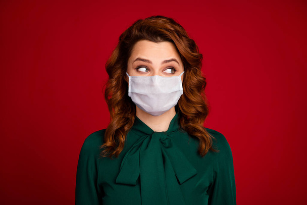 Close-up portrait nice-looking cheerful wavy-haired girl looking aside see covid infection quarantine enjoy she wear white medical mask isolated over bright shine red color background - Photo, image