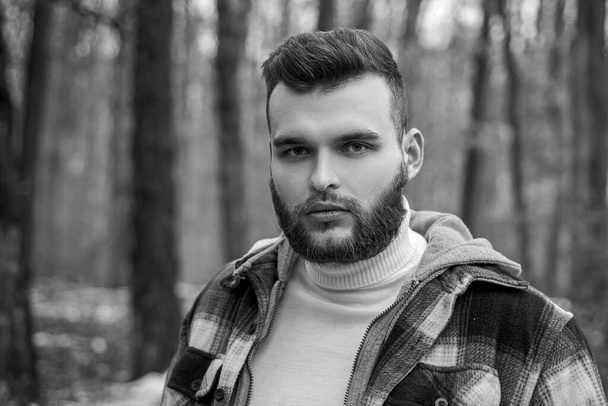 Well groomed hipster. Lumbersexual concept. Bearded lumberjack checkered clothes. Brutal man walk in forest. Hipster lifestyle. Masculinity and brutality. Lumberjack style. Stylish guy lumberjack - Foto, Imagem