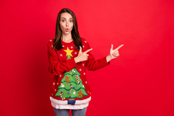 Portrait of nice-looking attractive pretty amazed stunned cheery girl demonstrating newyear advert advice copy space pout lips isolated bright vivid shine vibrant red color background - Foto, imagen
