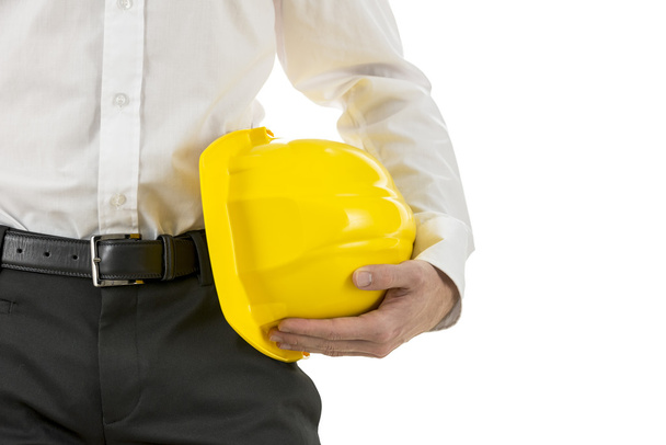 Ingénieur portant un casque jaune sous son bras
 - Photo, image