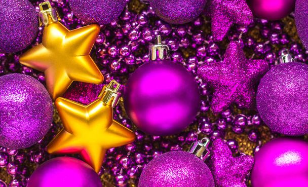 Background of purple Christmas balls and gold stars. Happy Christmas and new year - Fotó, kép