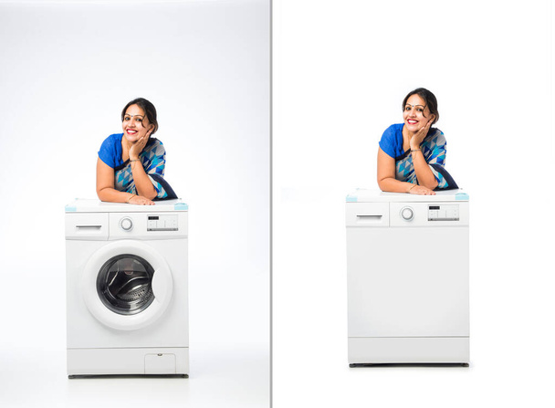 Индийская азиатская счастливая домохозяйка представляет посудомоечную машину или стиральную машину - Фото, изображение