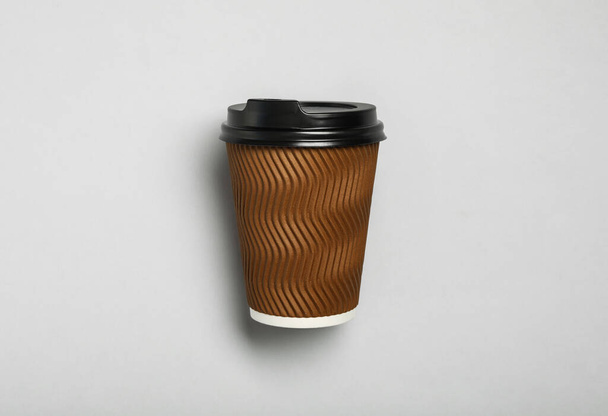 Takeaway paper coffee cup on light grey background, top view - Foto, imagen