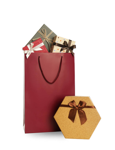 Paper shopping bag and gift boxes isolated on white - Fotó, kép