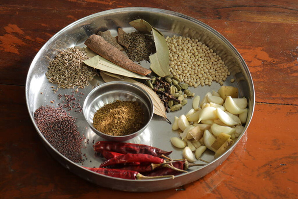 Various herbs and powder spices steel plate on wood background top view - Photo, Image