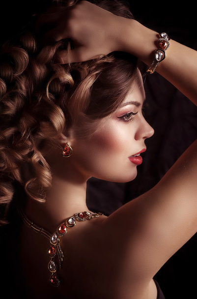 Young woman with makeup and with jewelry - Foto, Imagen