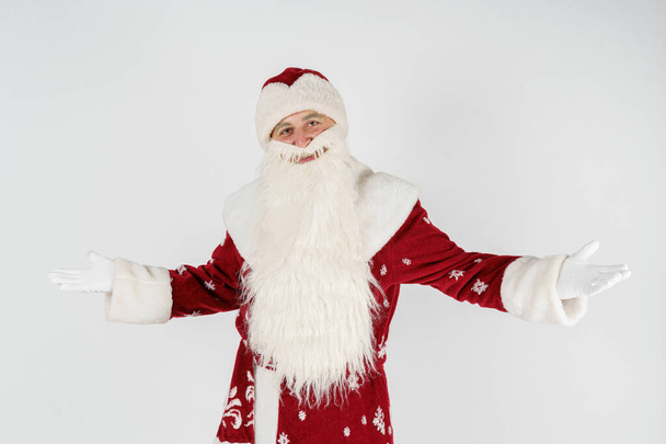 Christmas and New Years concept. Santa Claus gestures with his hands, spreading them apart from admiration. Isolated background. - Фото, изображение