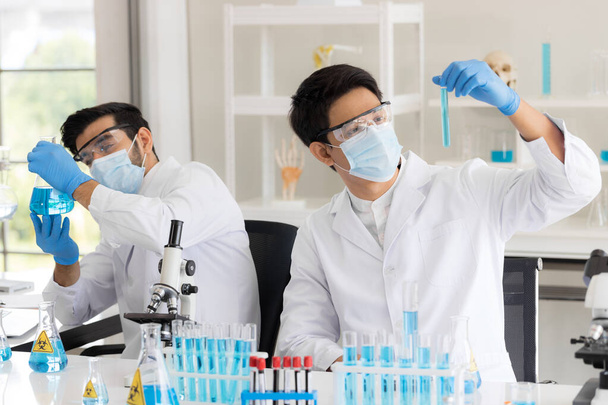 Health care researchers working in life science laboratory. Male research scientist and supervisor preparing and analyzing in research lab. Invention of the coronavirus vaccine - Photo, Image