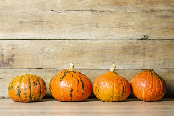 Pumpkins on a wooden background. Halloween concept, harvest, halloween eve. - Foto, Imagem