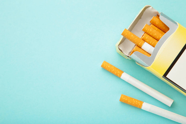Pack of cigarettes on blue background. Top view. - Foto, Bild