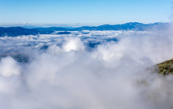 The so-called sea of clouds above the lowlands, and above them emerging mountain ranges. - Photo, Image