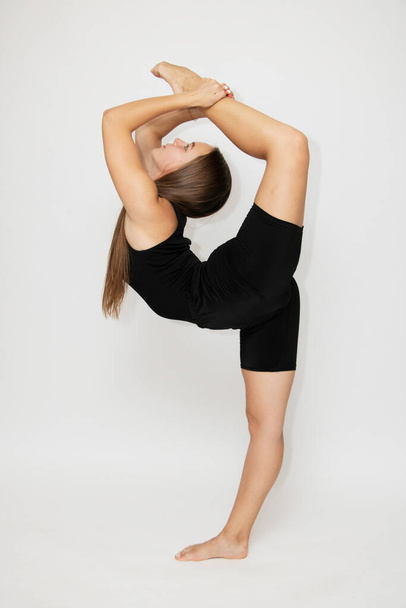 Beautiful girl hair engaged in yoga stretching fitness white background. - Foto, Imagem