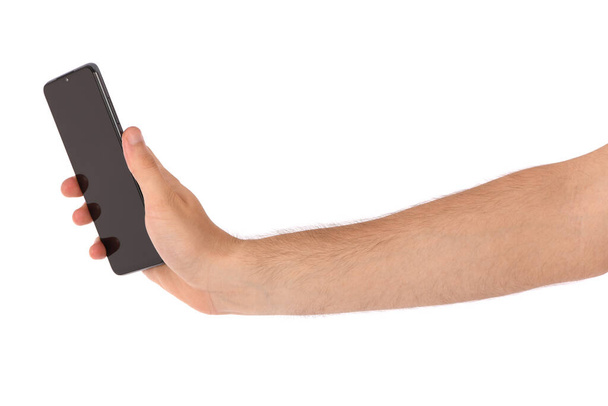 Main d'homme tenant le smartphone noir avec écran vierge. isolé sur fond blanc. Photo haute résolution. Profondeur de champ complète. - Photo, image